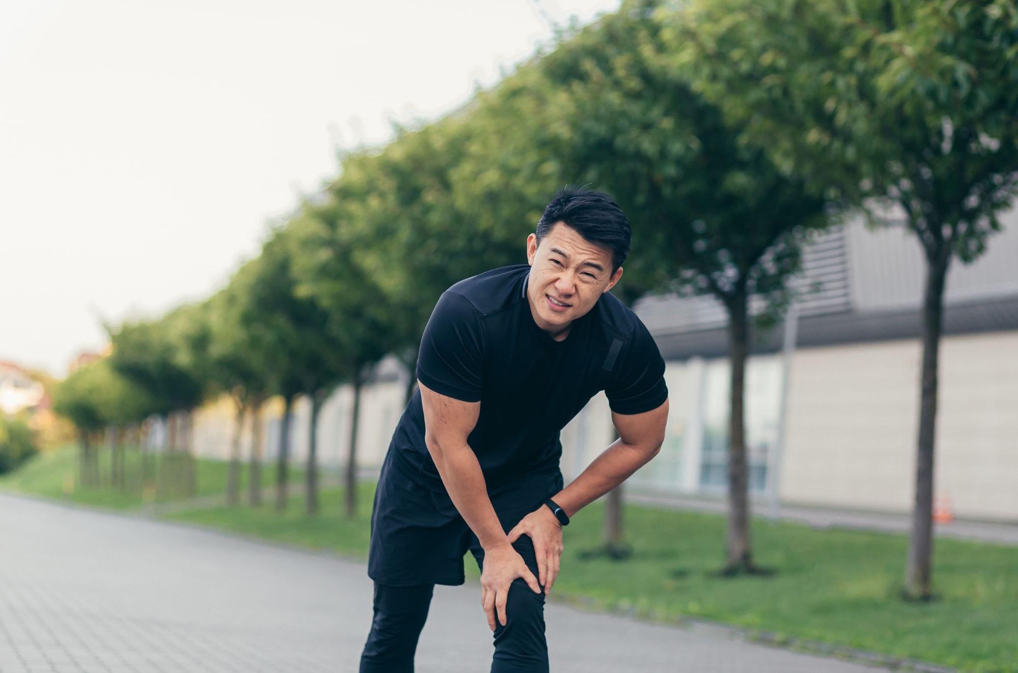 A Man Suffering From Knee Pain After Running.